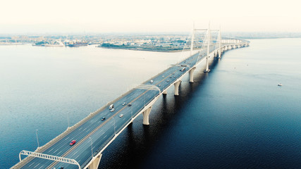 Fototapeta na wymiar cable-stayed bridge with high pylons and speeding cars