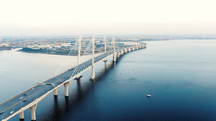 Fototapeta na wymiar flycam moves above long cable-stayed bridge with pylons