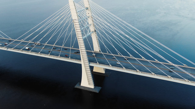 flycam shows modern cable-stayed bridge with pylons and cars