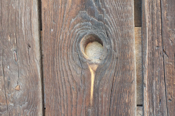 Wooden door with a little hole in the middle, closeup