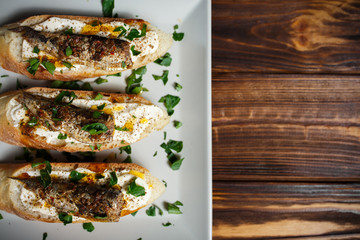toast with sardines on a wood background closeup. top view