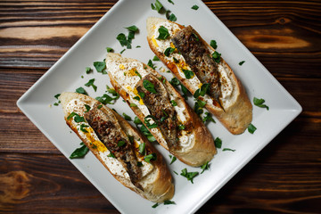 toast with sardines on a wood background closeup. top view