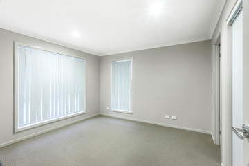 Carpeted bedroom with grey walls