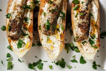 toast with sardines on a wood background closeup. top view
