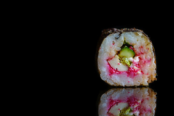 Sushi roll isolated on a dark background.