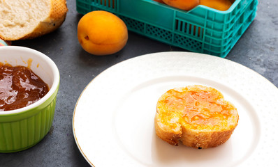 breakfast with apricot jam and slice of bread