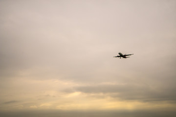 Aircraft on a background of cloudy sky. Landing a liner close-up. Spring. Day.