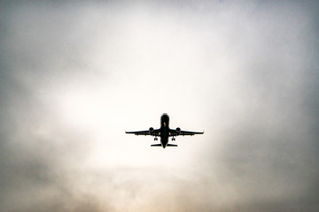 Aircraft on a background of cloudy sky. Landing a liner close-up. Spring. Day.