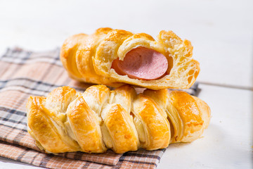 sausage in the dough, hot dog. Fresh pastries on a white background