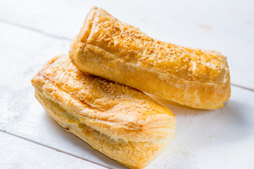 Fresh pastries on a white background close-up. Several rolls with filling on a white background