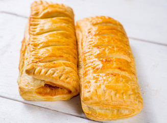 Fresh pastries on a white background close-up. Several rolls with filling on a white background
