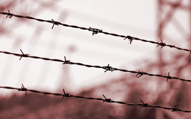 barbed wires and blurred objects with red toned effect