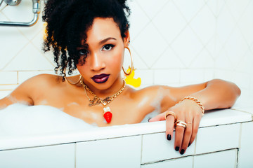 Obraz premium young pretty african american girl taking bath with foam, lifestyle people concept
