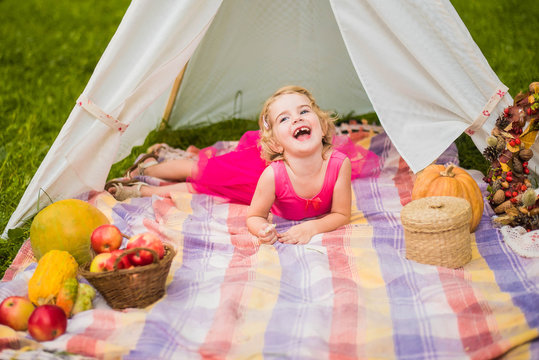 small girl smailling on autumn picnic