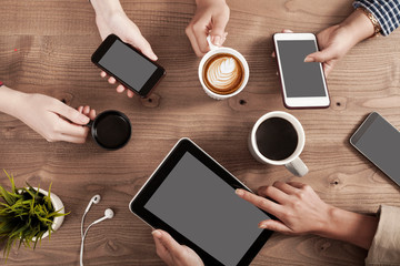 Three young women enjoy coffee at a coffee shop