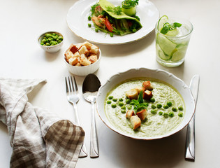 Green lunch for one person. Сream soup with green peas.Сpinach tortilla. Сucumber lemonade