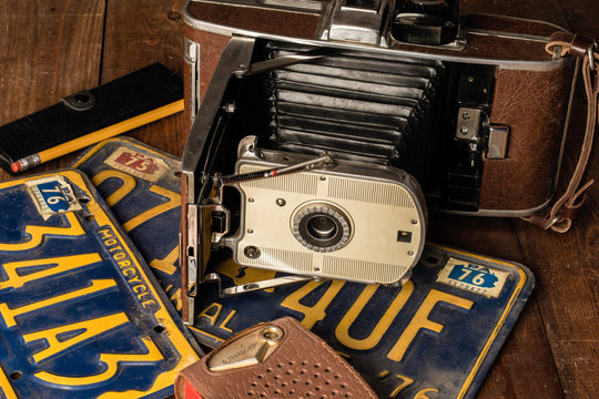 old camera and vintage transistor radio on old license plates 