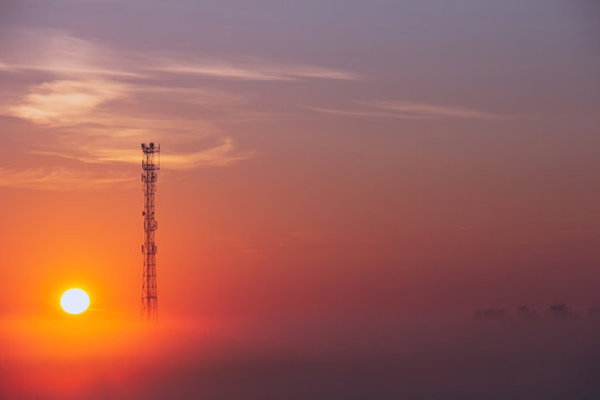 Cell Tower In The Fog During Sunrise