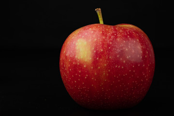 Tasty ripe apple on a dark table. Rich berries prepared to eat.