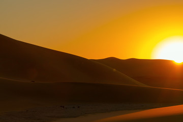 Fototapeta na wymiar Sunset over the sand dunes in the Namib desert.