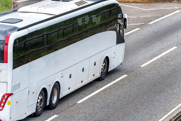 white bus coach on uk motorway in fast motion