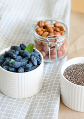 Healthy food with honeysuckle, granola and nuts, selective focus. Ingredients for a healthy breakfast, nuts, berries. The concept of a healthy food 