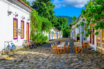 Street of historical center  with tables of restaurant in Paraty, Rio de Janeiro, Brazil. Paraty is...