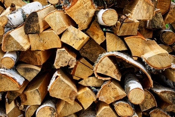 Stacked birch firewood prepared for kindling. Eco-friendly and natural items