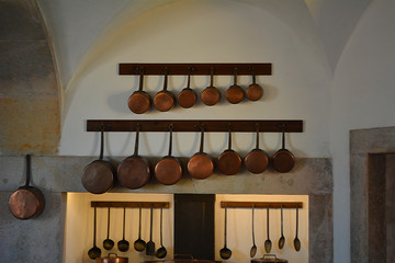 Old Victorian Kitchen With Rows of Copper Pots and Pans Hang from the Wall