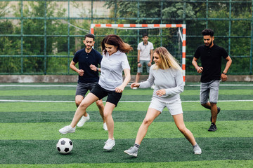 Running soccer football players. Footballers kicking football match game.