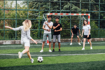 Portrait of successful female soccer players  play football together.