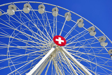 Swiss flag on white Ferris wheel, Geneva Switzerland