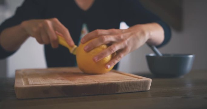 Young woman cutting up a grapefruit