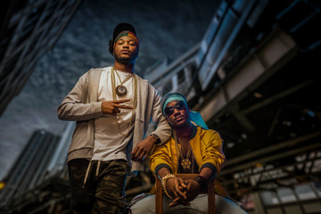 Two black rappers poses on night city street - obrazy, fototapety, plakaty