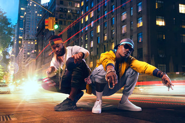 Two black rappers dancing on city street - obrazy, fototapety, plakaty