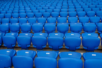 Naklejka premium Rows of blue seats in the stand in the sports arena