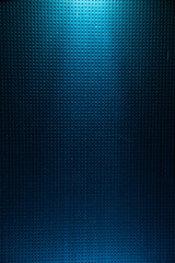 A light blue diffused light beam from above illuminates the blue background to a point