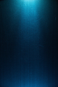 A light blue diffused light beam from above illuminates the blue background to a point