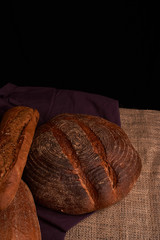 Frash assortment of baked bread on sacking background viewed from above. Top view