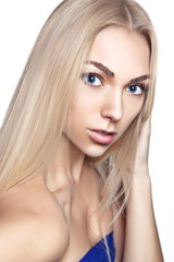 Fototapeta premium Portrait of young beautiful girl with long blond hair and natural make-up
