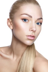Fototapeta premium Portrait of young beautiful girl with long blond hair and natural make-up