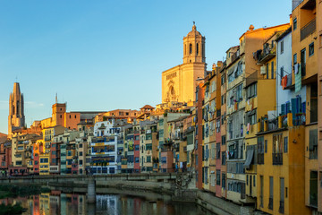 Fototapeta na wymiar Colorful yellow and orange houses reflected in water, Girona