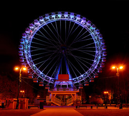Ferris wheel in a night amusement park.