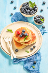 Top view of american pancakes with fresh blueberries and sugar