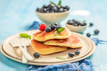 American pancakes for breakfast on blue table