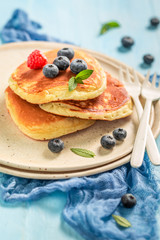 Closeup of american pancakes for breakfast on blue table
