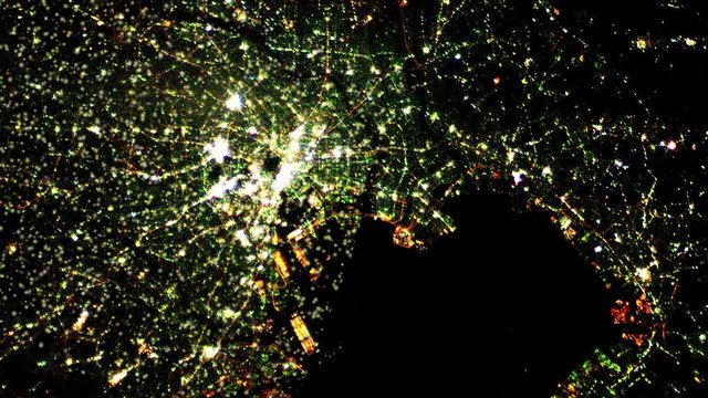 Tokyo city satellite view by night with animated flashing lights. Contains public domain image by Nasa