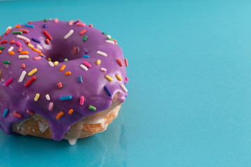 Purple Glazed Donut with Rainbow Sprinkles on Top
