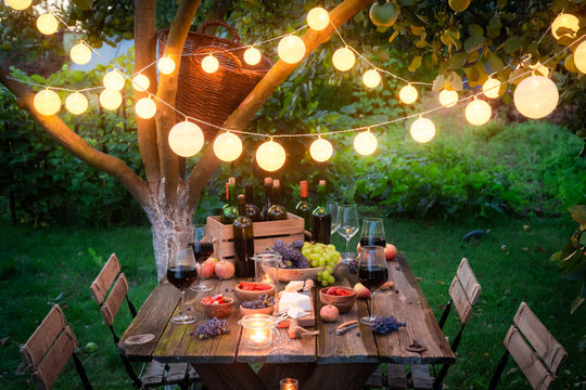 Rustic table with snacks and wine in the summer evening