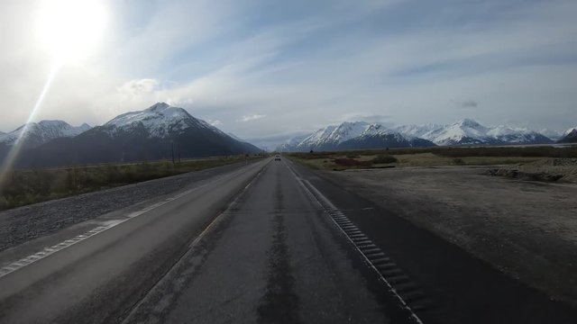 POV; Driving the Seward Highway through the Chugach National Forest through the Ingram Creek Valley along in Alaska, with Chugach Mountains on either side of the valley
